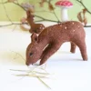 Handmade little felt grazing doe