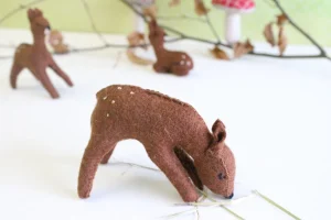 Handmade little felt grazing doe